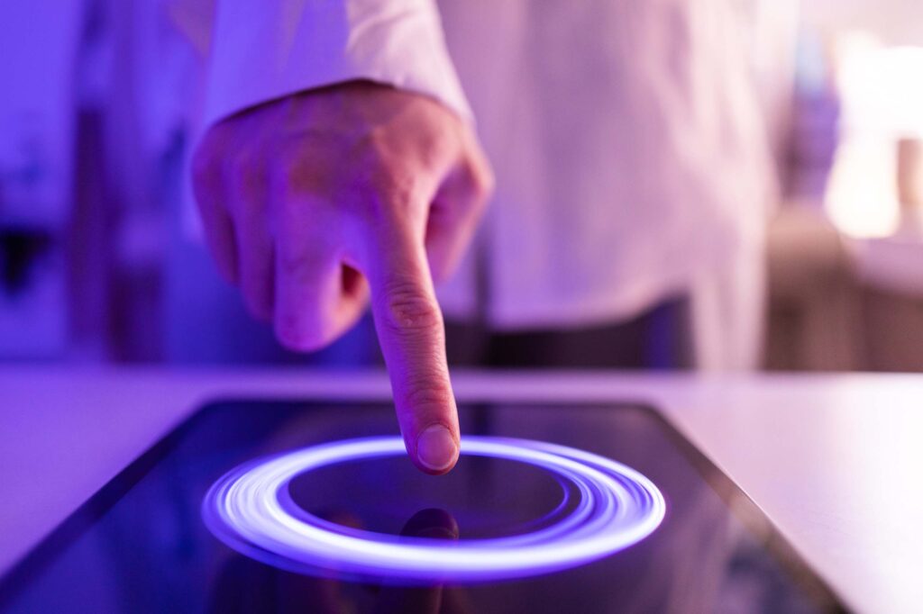 A closeup of a hand pressing a button on a screen