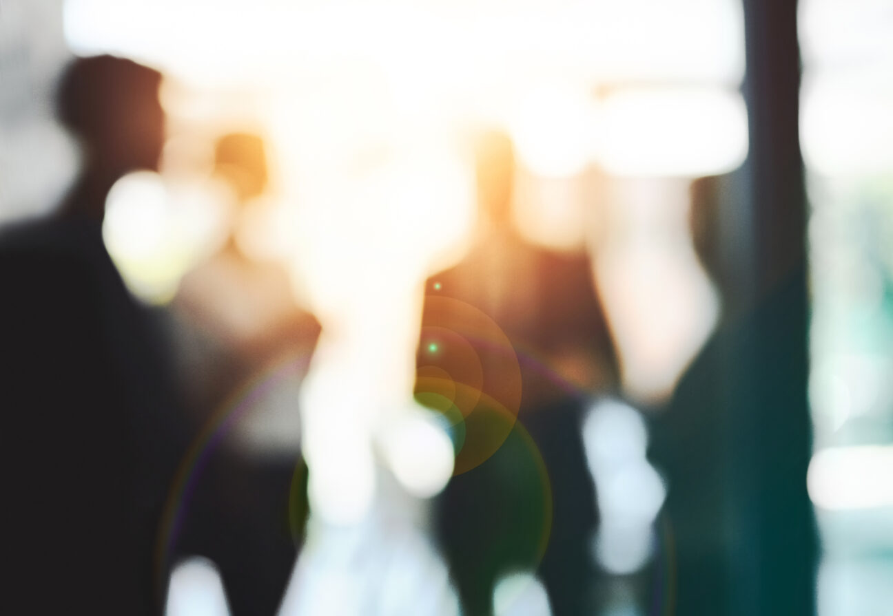 AWS Cloud Readiness Assessment image: a blurry silhouettes of people with light shining through them