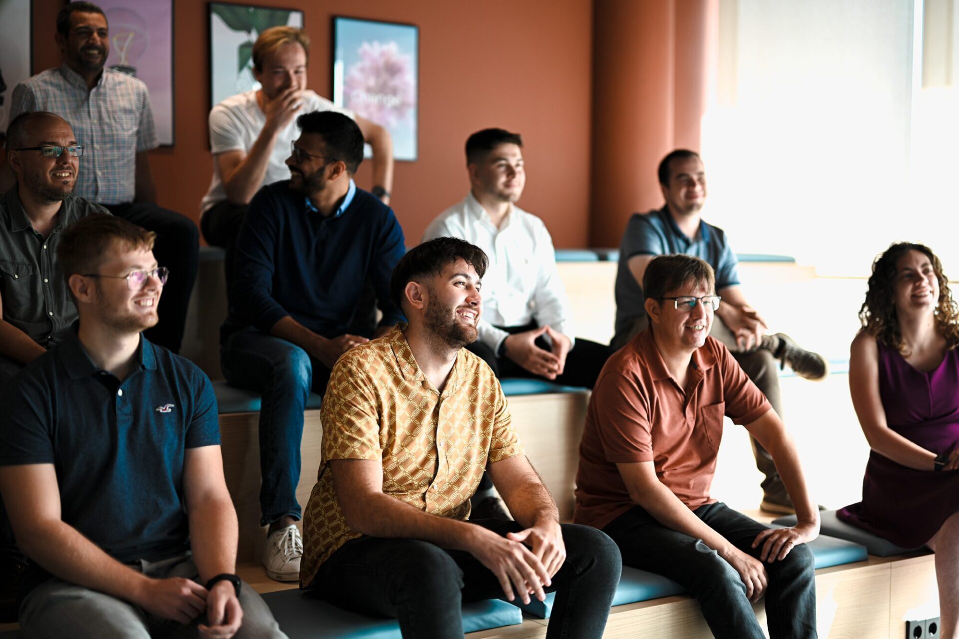 Devoteam Data team: a group of smiling people sitting together in an office