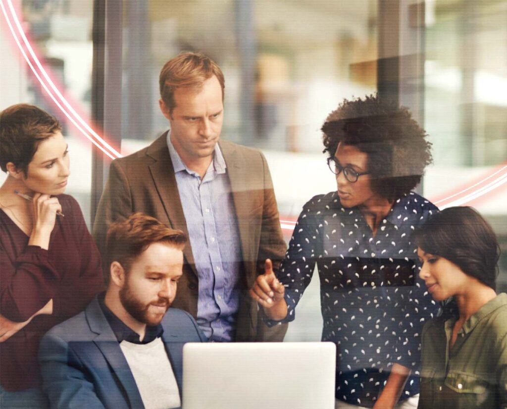 A group of men and women looking at a screen together and discussing