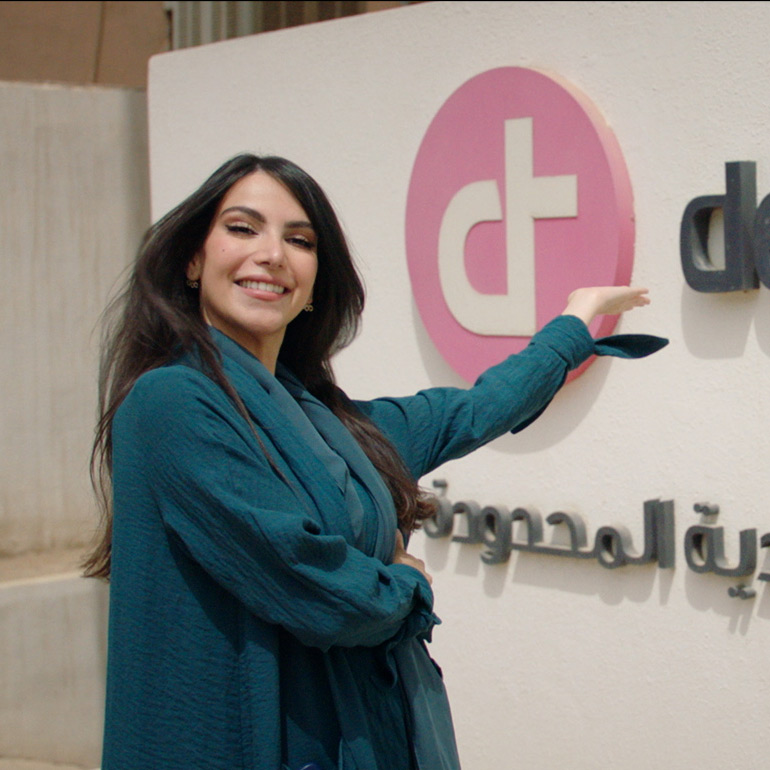 Devoteam values: Respect - a woman pointing to a Devoteam logo
