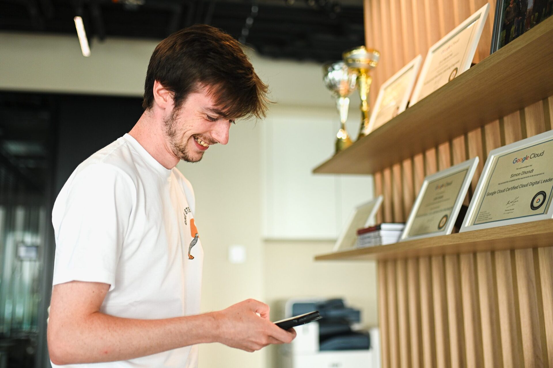 Devoteam Multi Cloud team: a man smiling and looking at his phone