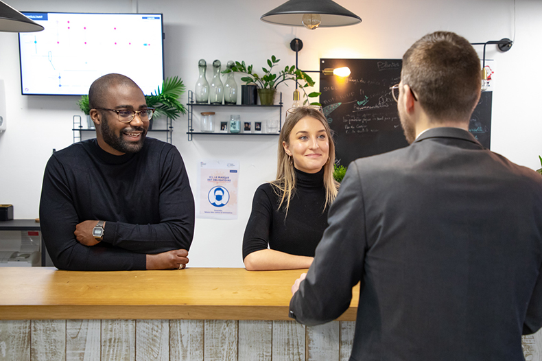 A man and woman sit together at a counter, enjoying a conversation and sharing a moment of connection.