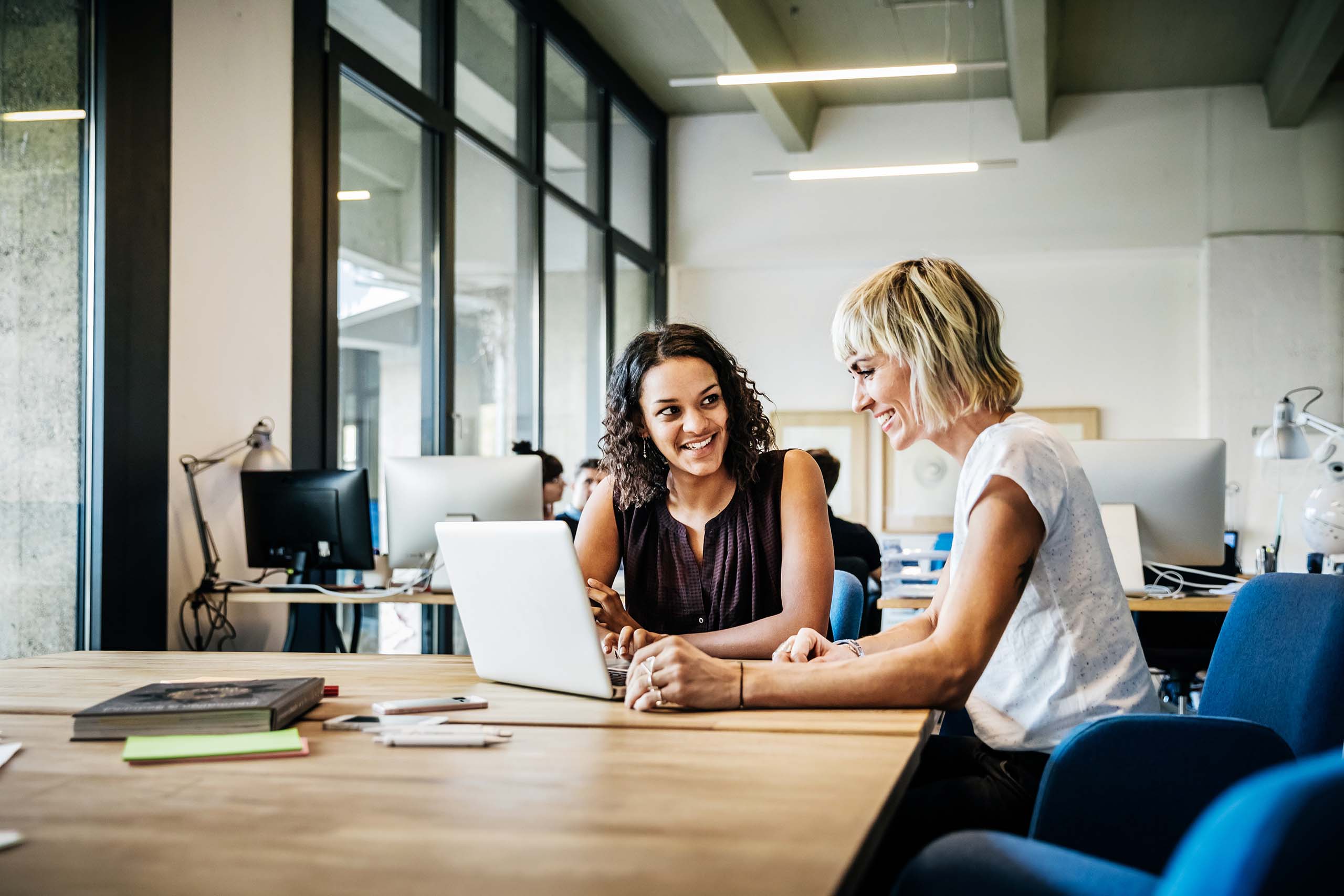 Two women collaborating in an office.
